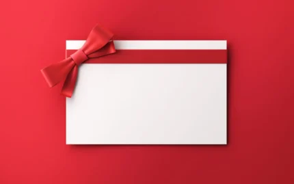 White gift card with red ribbon and bow
