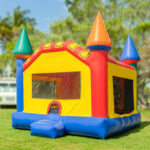 Colorful inflatable bounce house on grassy lawn