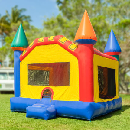 Colorful inflatable bounce house on grassy lawn