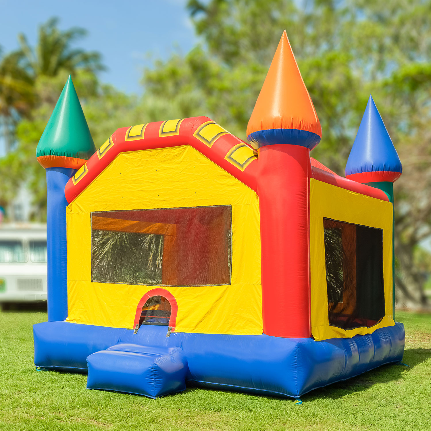 Colorful inflatable bounce house on grassy lawn